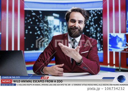 Wild animal escapes from zoo causing panic in city, free wildlife on streets mobilize authorities to help citizens. News reporter on night show presenting latest events, reading headlines. 106734232