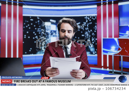 Anchorman reveals museum on fire breaking news, many artifacts and artworks are in danger of burning. News broadcaster being worried about historical pieces at famous landmark. 106734234