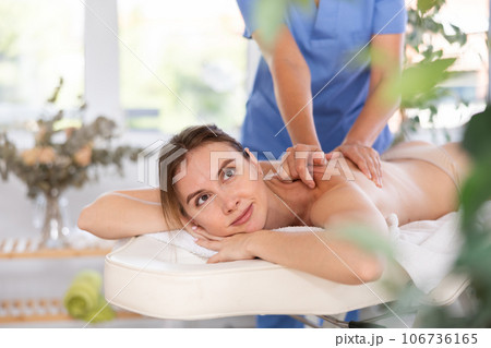 Young woman enjoying massage from professional female masseur 106736165
