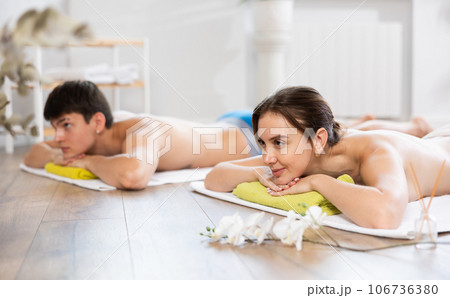 Relaxed young woman lying on the floor during aromatherapy procedure 106736380