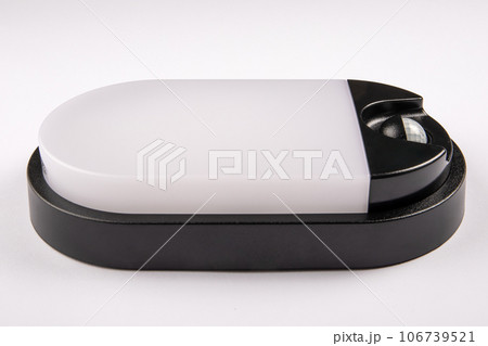 Led lamp with a motion sensor on a white background. Close up Led lamp with a motion sensor on a white background. Close up 106739521
