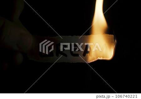 A man holds a paper with the inscription - Dream in his hands, which he then burns. 106740221