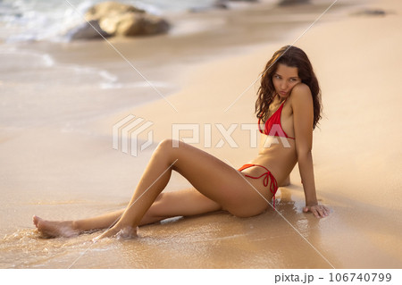 Funny Woman in Red Bikini Sitting on Beach with Mixed Emotions Funny Woman in Red Bikini Sitting on Beach with Mixed Emotions 106740799
