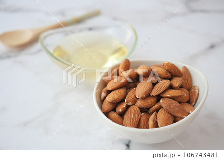 almond oils and fresh nuts on table almond oils and fresh nuts on table 106743481