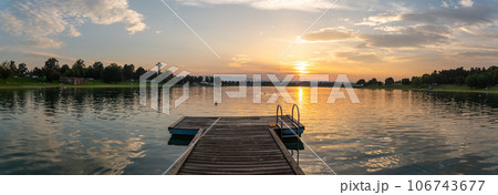 Lake schwarzl sunset panorama schwarzlsee near the styrian capitol Graz in Austria. Lake schwarzl sunset panorama schwarzlsee near the styrian capitol Graz in Austria. 106743677