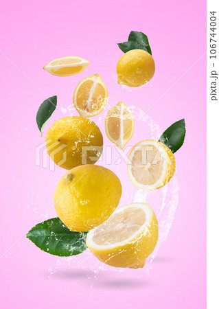 water splash on yellow lemon isolated on a pink background. 106744004