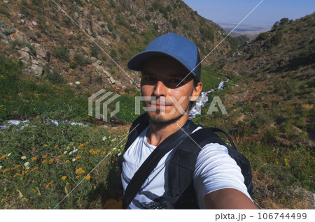 Selfie of a white Caucasian male tourist with beard on hike in the Kaskasu gorge by river in mountains in summer Selfie of a white Caucasian male tourist with beard on hike in the Kaskasu gorge by river in mountains in summer 106744499