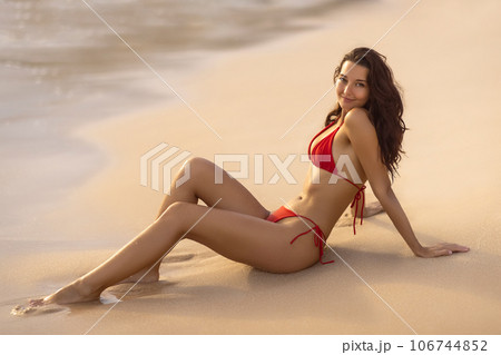 Beach Bikini Model in Red Swimsuit on Perfect Sandy Beach 106744852