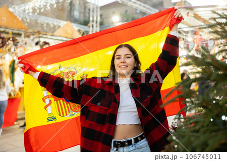 Girl waving Spain flag at street new year fair 106745011