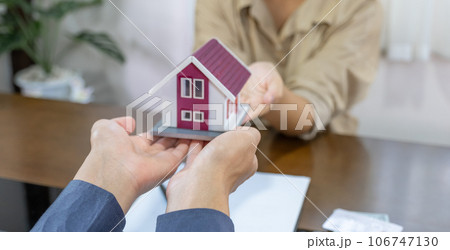 Real estate agents and buyers discuss signing a business contract, renting, buying, mortgage, loan or home insurance 106747130