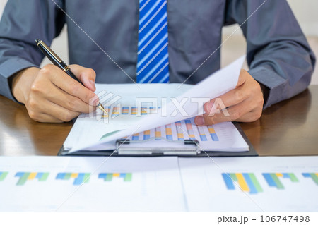 Businessmen bookkeeper hand holding pen doing account for paying tax in working office Businessmen bookkeeper hand holding pen doing account for paying tax in working office 106747498