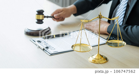 justice scale standing in front of the lawyer providing legal consult business dispute service at the office with gavel hammer justice scale standing in front of the lawyer providing legal consult business dispute service at the office with gavel hammer 106747562