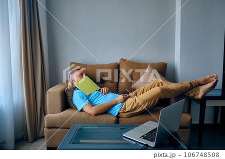 Tired man sleeps on sofa 106748508