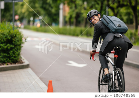 Manager commuting to the office by bike 106748569