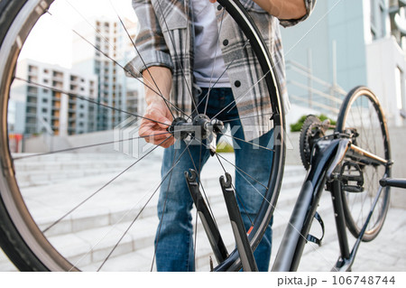 Man with a bike on the steps in the street Man with a bike on the steps in the street 106748744