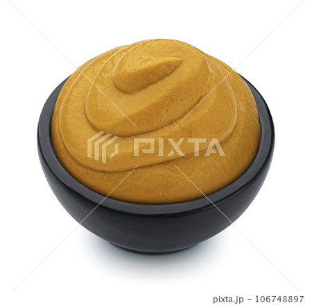 Mustard in black bowl isolated on white background, full depth of field 106748897