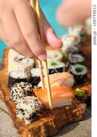 assorted sushi on a board near the pool 106749613