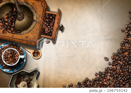 Coffee Grinder and Cup with Roasted Coffee Beans on a Blank Parchment 106750142