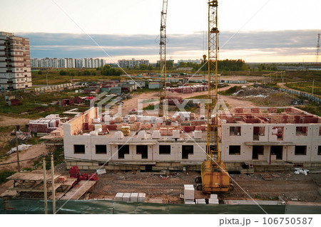 Construction site background. Hoisting cranes and new multi-storey buildings. I.ndustrial background. 106750587