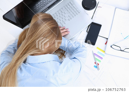 Tired businesswoman at workspace in office Tired businesswoman at workspace in office 106752763