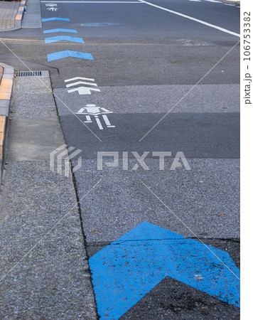 車道の左端に設置された自転車ナビマーク(白色)と自転車ナビライン(青色) 車道の左端に設置された自転車ナビマーク(白色)と自転車ナビライン(青色) 106753382