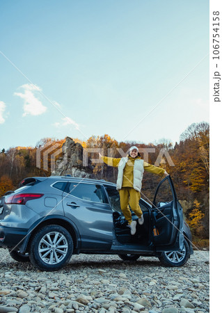 happy woman car traveler at rocky river beach happy woman car traveler at rocky river beach 106754158