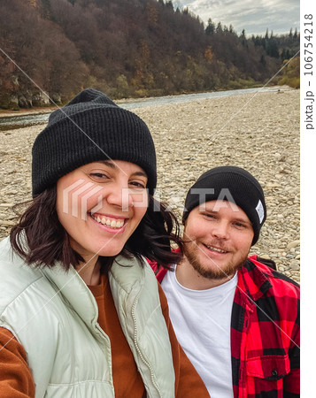 happy couple travelers taking selfie at the river beach 106754218