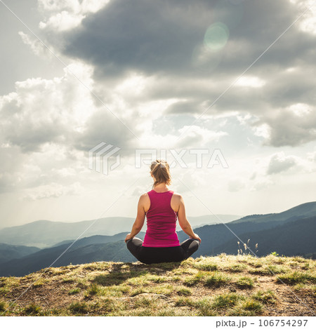 Young woman on the top of mountain 106754297