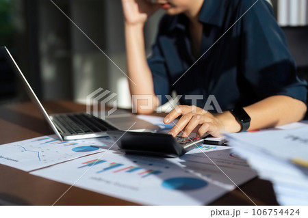 Close up of businessperson analysis and calculate chart and graph showing change and growth on the finance and marketing 106754424