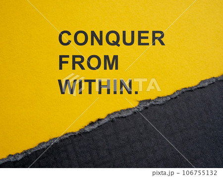 Torn piece of paper and motivation phrase conquer from within. 106755132