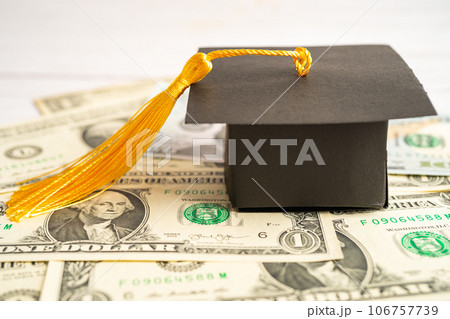 Graduation gap hat on Euro and US dollar banknotes money, Education study fee learning teach concept. 106757739
