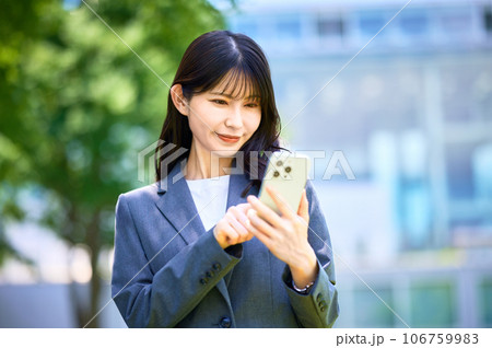 スマートフォンを操作するビジネスウーマン スマートフォンを操作するビジネスウーマン 106759983