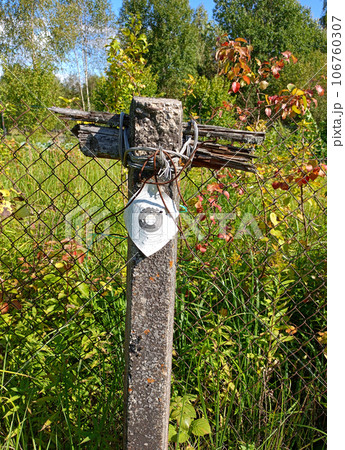 A fence post with a target printed on paper for sport shooting 106760307