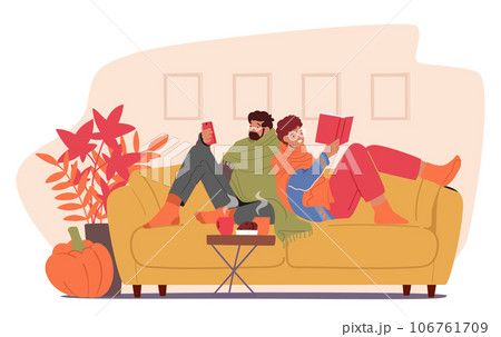 Content Couple Snuggled On The Couch, Engrossed In A Book And Phone, Basking In The Warmth Of Autumn Hues Content Couple Snuggled On The Couch, Engrossed In A Book And Phone, Basking In The Warmth Of Autumn Hues 106761709