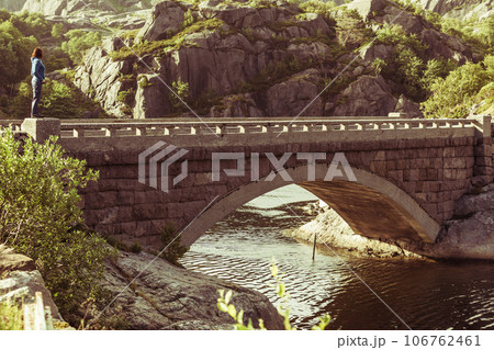 Female tourist on old bridge in Norway Female tourist on old bridge in Norway 106762461