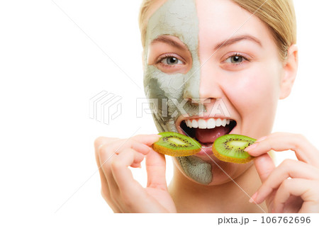 Skin care. Woman in clay mask with kiwi on face 106762696