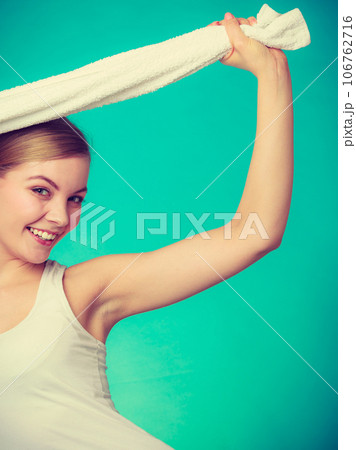 Woman with a towel above her head Woman with a towel above her head 106762716