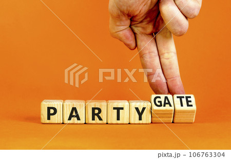 Party and partygate symbol. Concept words Party and Partygate on wooden cubes. Businessman hand. Beautiful orange table orange background. Business party and partygate concept. Copy space. Party and partygate symbol. Concept words Party and Partygate on wooden cubes. Businessman hand. Beautiful orange table orange background. Business party and partygate concept. Copy space. 106763304