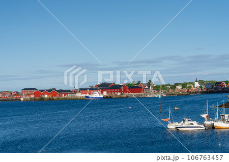 Summer in Reine, Lofoten Islands, Norway. Popular tourist destination. Old fishermans village with wooden red cottages Summer in Reine, Lofoten Islands, Norway. Popular tourist destination. Old fishermans village with wooden red cottages 106763457