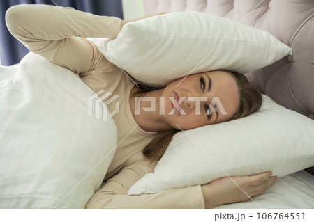 A beautiful woman can't sleep. Noisy neighbors keep you awake. Severe headache makes it difficult to sleep A beautiful woman can't sleep. Noisy neighbors keep you awake. Severe headache makes it difficult to sleep 106764551
