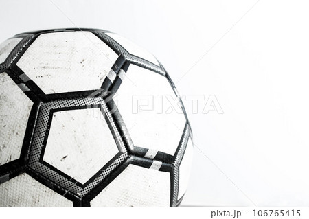 Dirty soccer ball close-up on a white background. 106765415