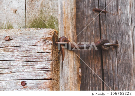 Old bolt. Vintage castle. Door on a hook. Old wooden fence. Old bolt. Vintage castle. Door on a hook. Old wooden fence. 106765828
