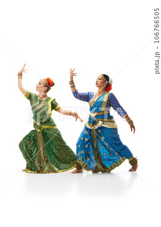 Sattriya dance. Women, in beautiful traditional indian dresses dancing against white studio background 106766505