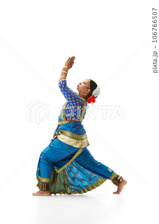 Elegant, artistic indian woman in traditional dress dancing against white studio background 106766507