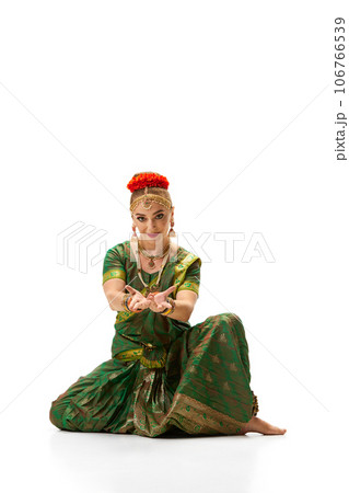 Bharatanatyam dance. Beautiful, elegant woman with makeup, in traditional accessories and dress against white studio background 106766539