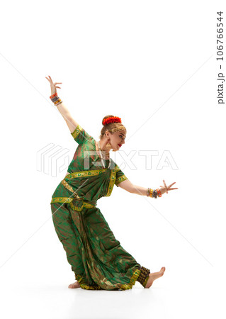 Elegance of indian culture. Beautiful woman dancing indian dance against white studio background Elegance of indian culture. Beautiful woman dancing indian dance against white studio background 106766544