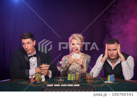 Group of a young wealthy friends are playing poker at a casino. Group of a young wealthy friends are playing poker at a casino. 106766591