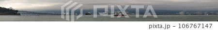 Panoramic of Ferry racing by the Bay bridge and the east bay 106767147