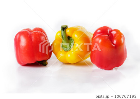 Red and yellow pepper on white, close-up 106767195