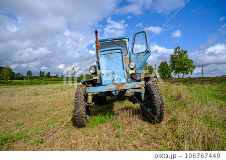 Old blue Russian agricultural tractors in the field. Agricultural machinery in the farm. Special Agricultural Equipment. Durable agricultural machinery 106767449